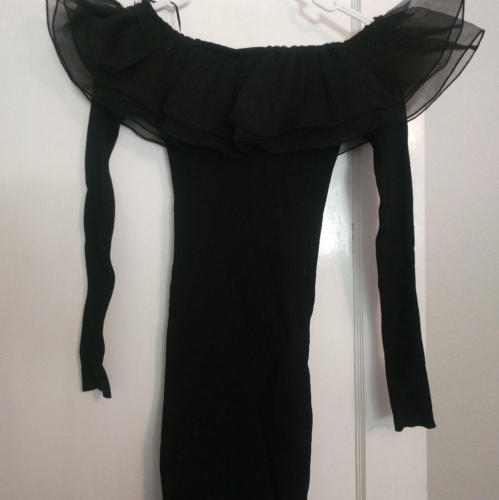 Women's bodycon dress with ruffle shoulders.